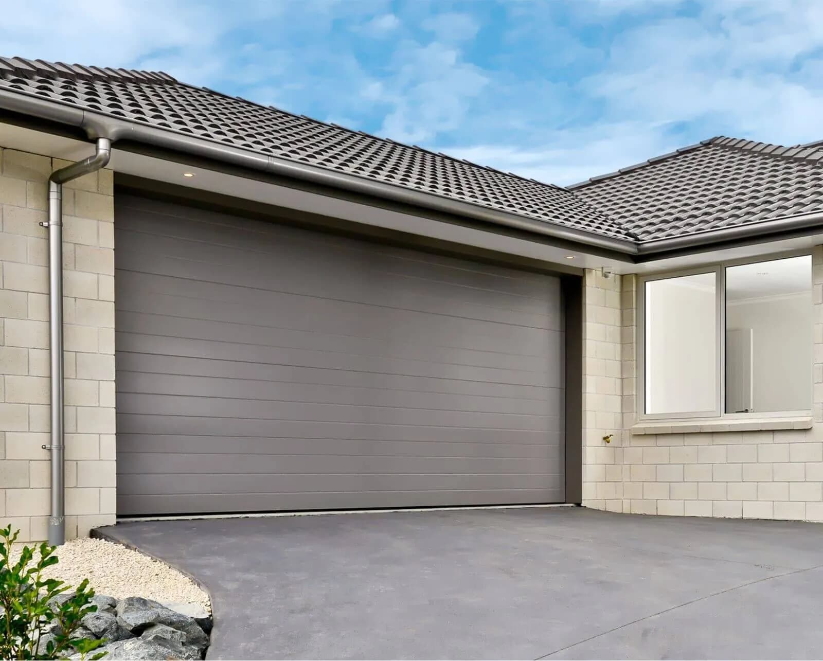 Dominator garage door on a modern home — manufacturer image