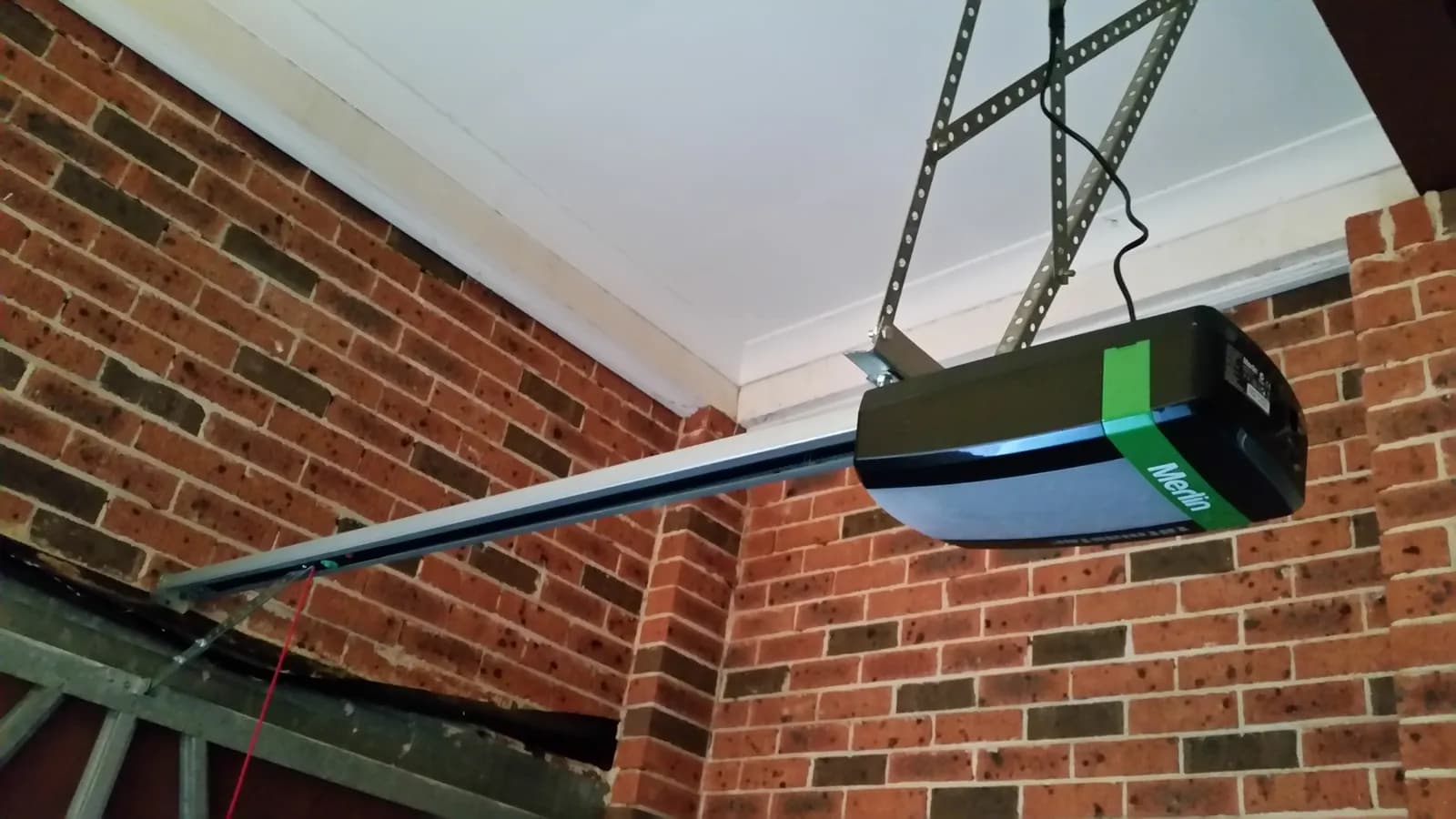 Merlin garage door opener head unit mounted on a garage ceiling in Australia