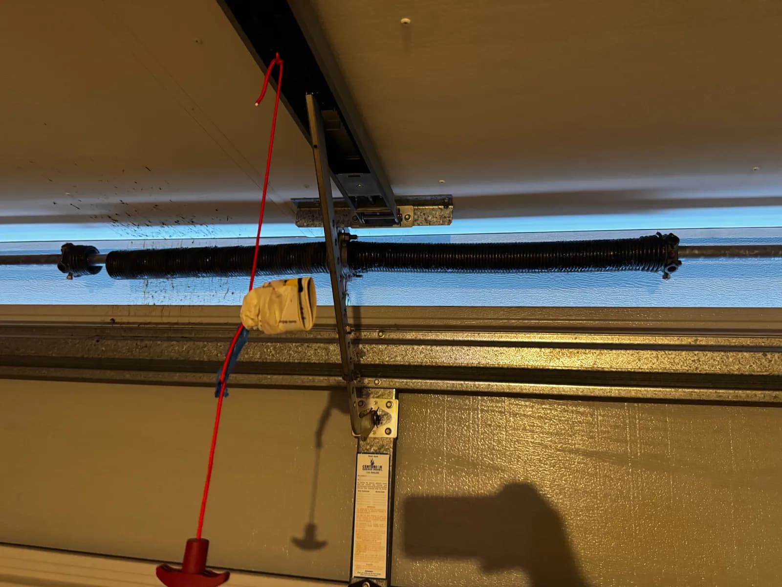Snapped torsion spring with a visible gap in the coils above a sectional garage door in East Cannington, Perth Snapped torsion spring with a visible gap in the coils above a sectional garage door in East Cannington, Perth