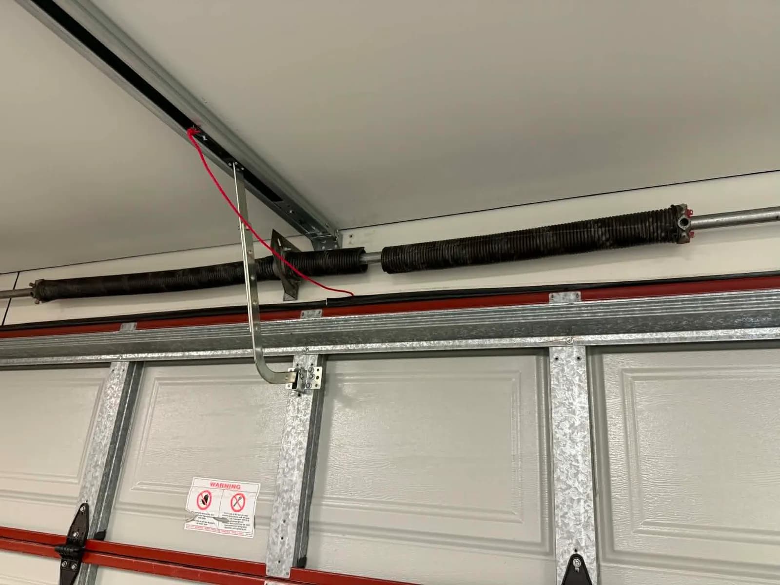 Twin garage door torsion springs on the shaft in Duncraig with one spring snapped Twin garage door torsion springs on the shaft in Duncraig with one spring snapped