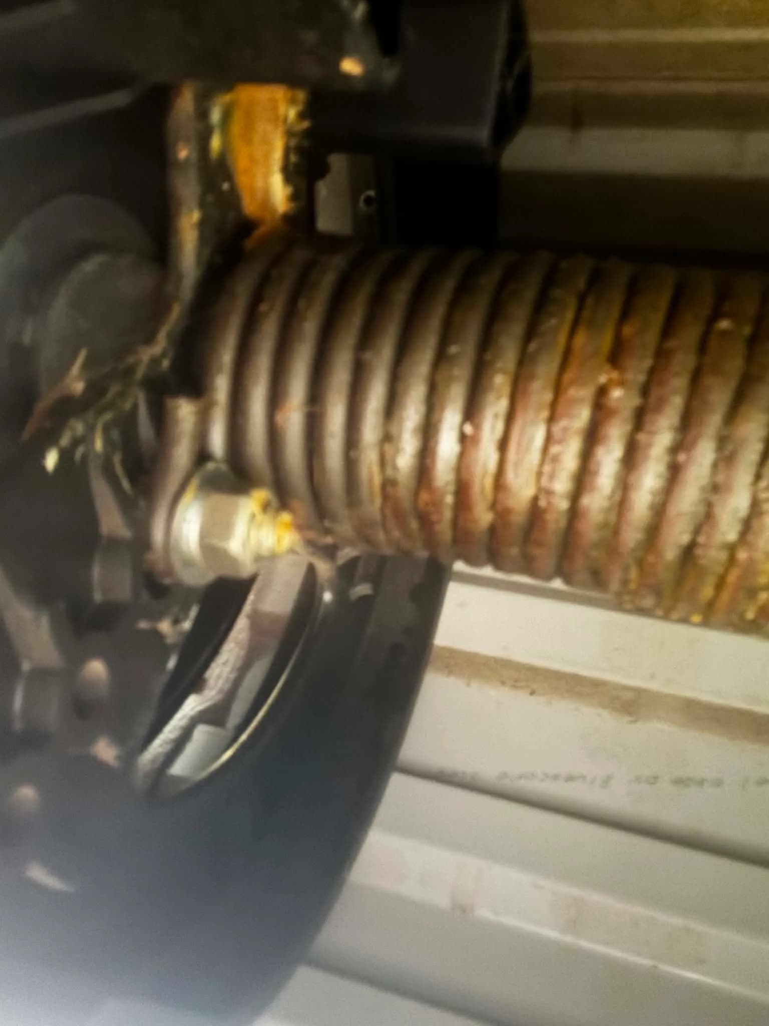 Badly corroded, rust-covered garage door torsion spring in Armadale Badly corroded, rust-covered garage door torsion spring in Armadale