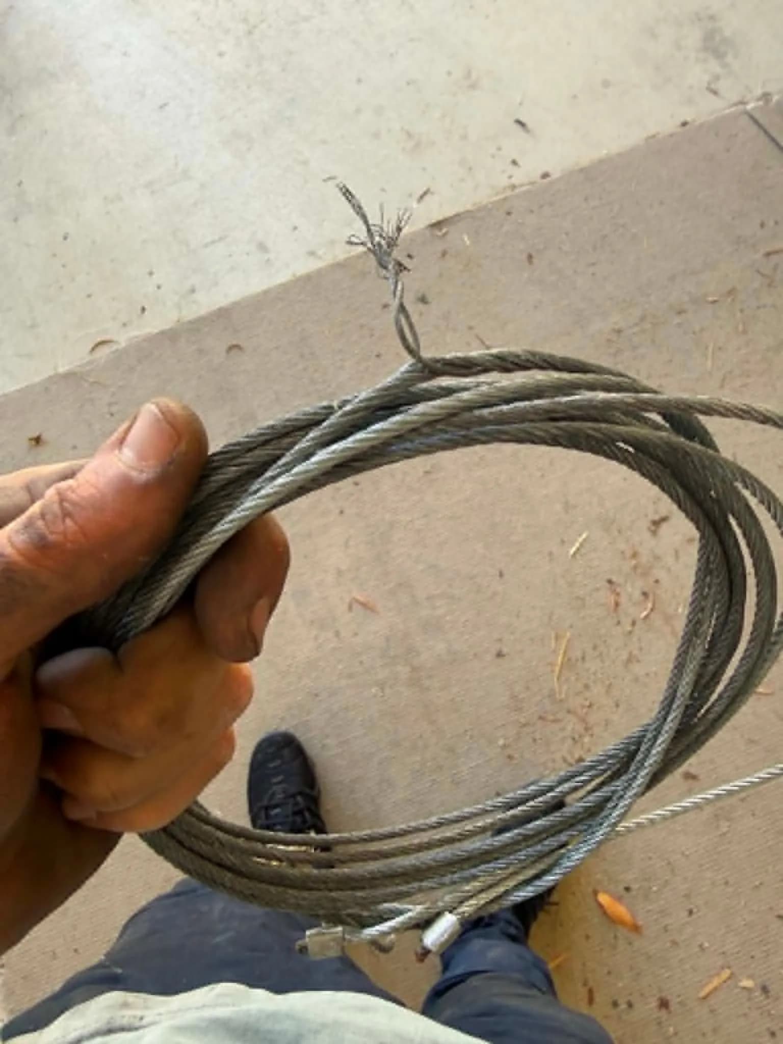 Frayed, snapped garage door lift cable removed from a sectional door in Forrestfield, Perth Frayed, snapped garage door lift cable removed from a sectional door in Forrestfield, Perth