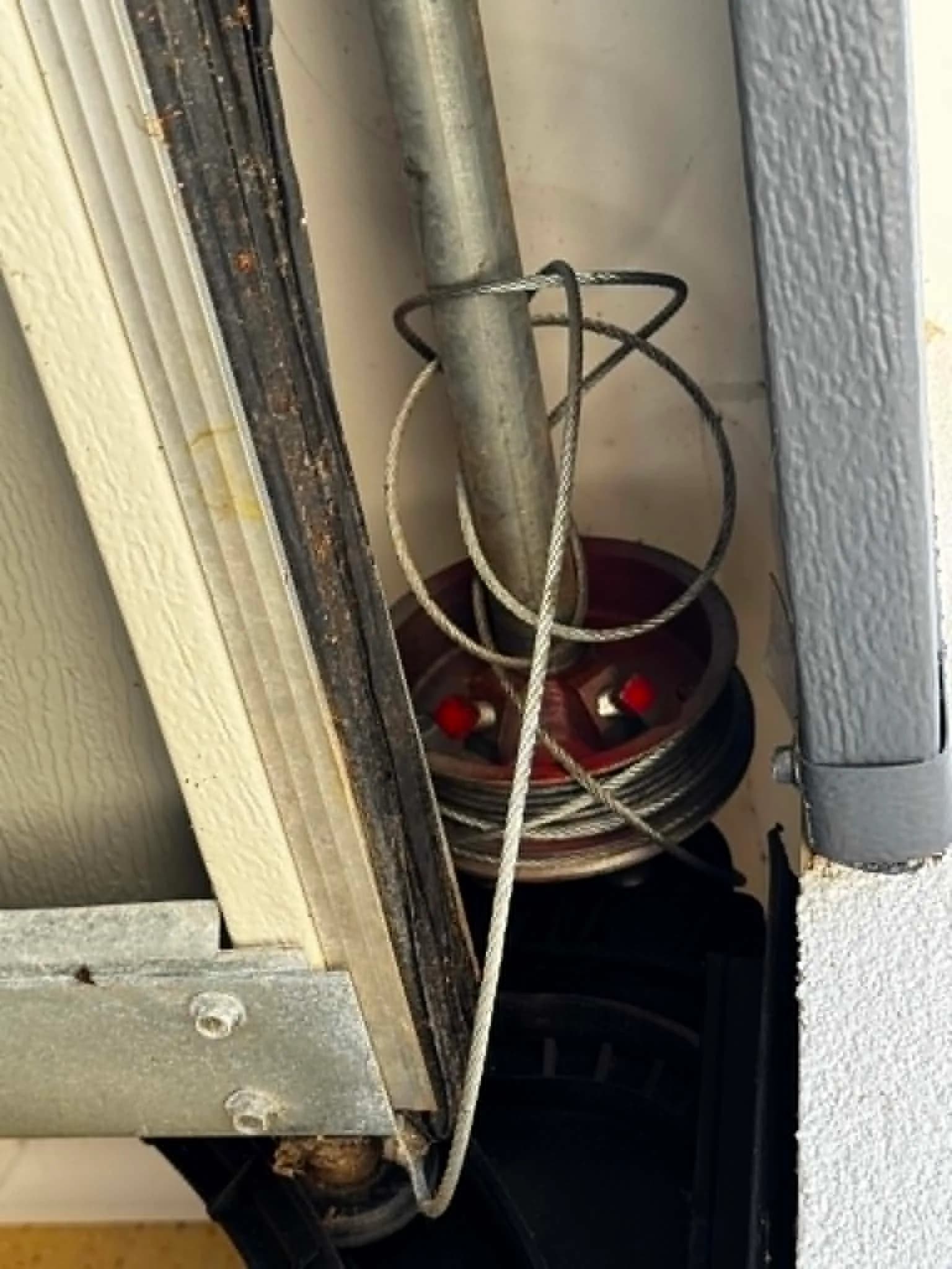 Lift cable unwound from the cable drum on a Fremantle garage door out of alignment Lift cable unwound from the cable drum on a Fremantle garage door out of alignment