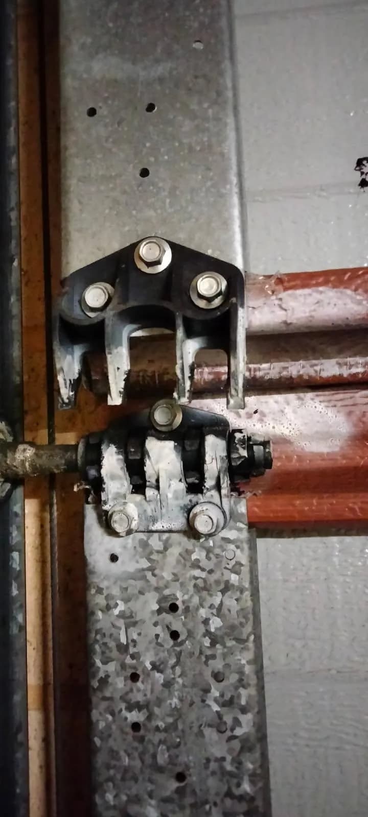 Worn, corroded garage door hinge and roller bracket before replacement in Morley Worn, corroded garage door hinge and roller bracket before replacement in Morley