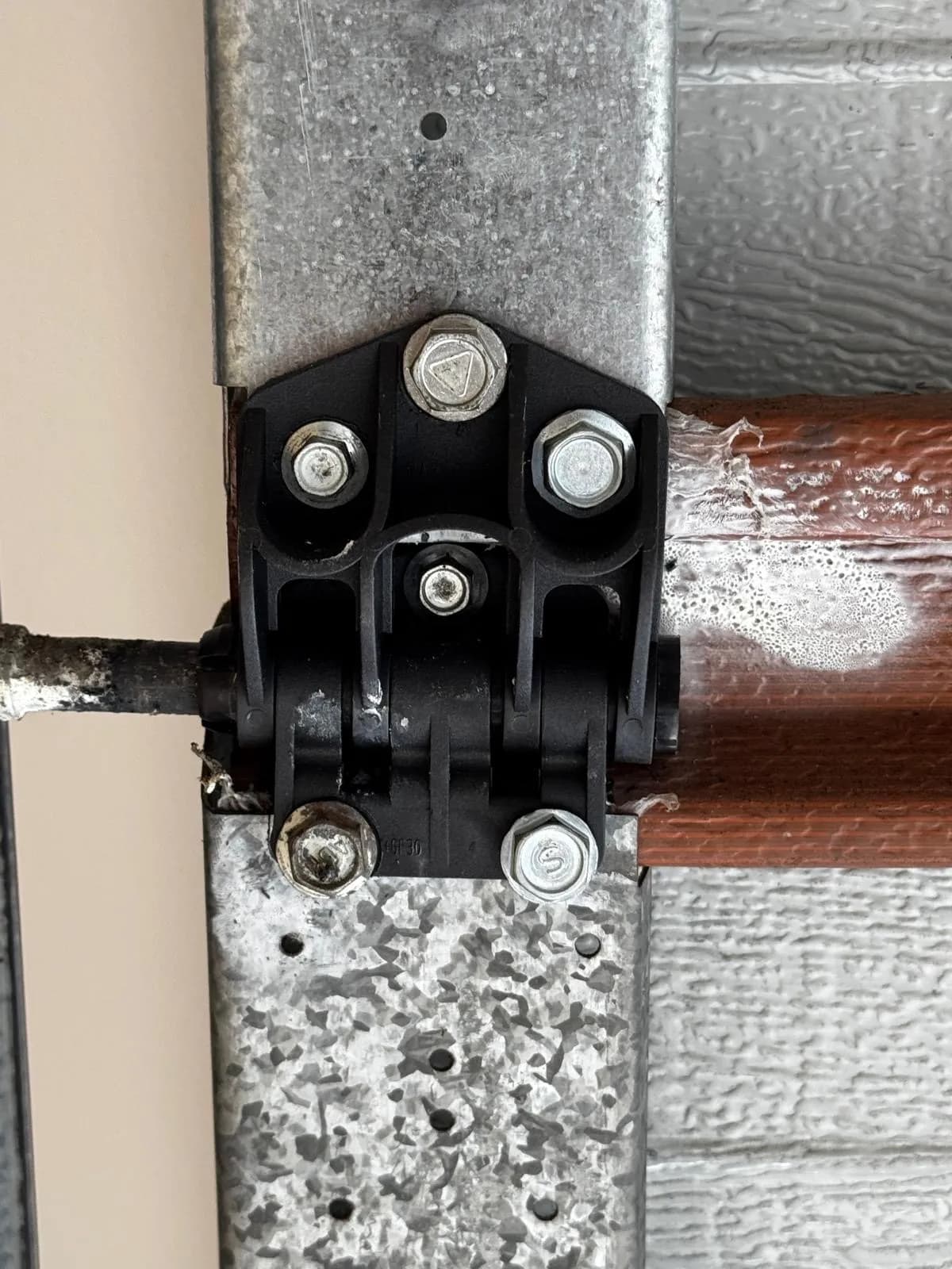 New black hinge and roller bracket fitted to a Morley garage door track New black hinge and roller bracket fitted to a Morley garage door track