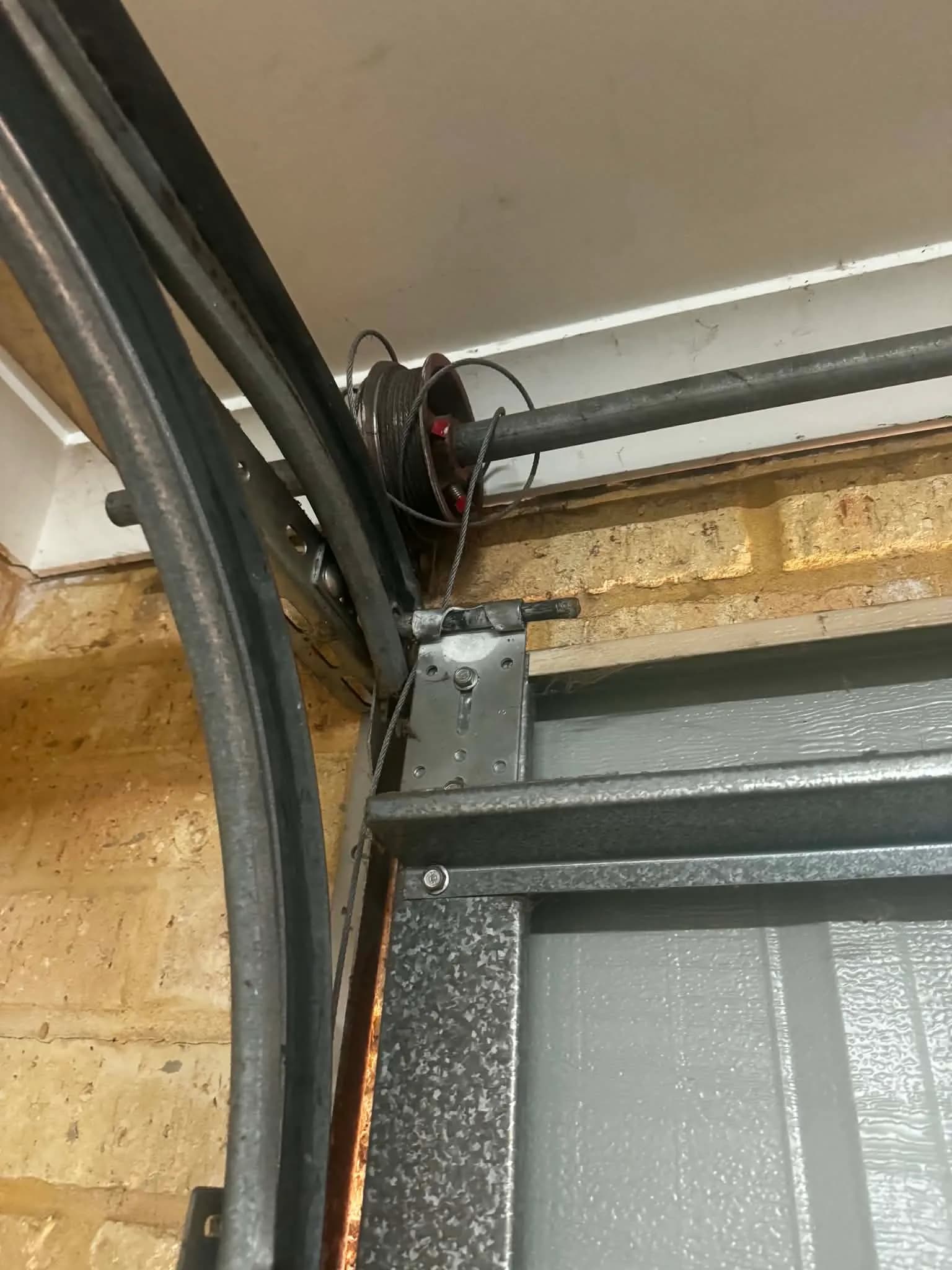 Frayed lift cable coiled around a red cable drum in a Bayswater garage Frayed lift cable coiled around a red cable drum in a Bayswater garage