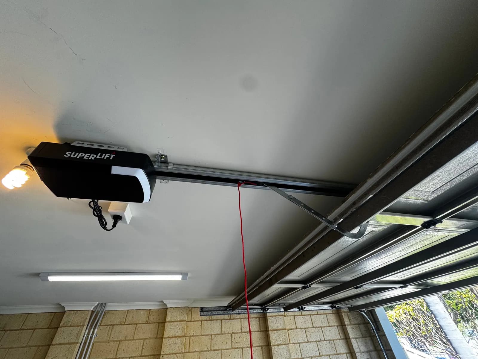 New Superlift garage door opener with LED light on the ceiling rail above a sectional door in Belmont, Perth New Superlift garage door opener with LED light on the ceiling rail above a sectional door in Belmont, Perth