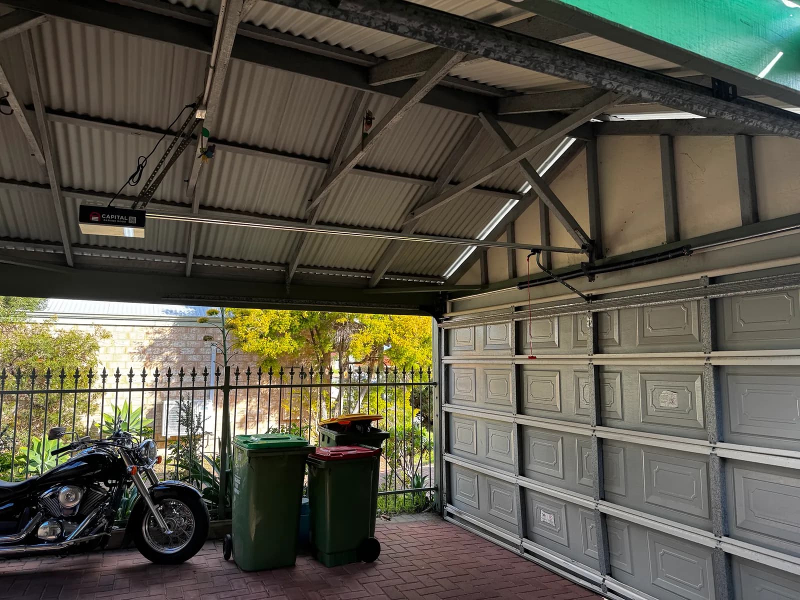 The repaired sectional door open above the Kardinya driveway, Capital motor on the ceiling The repaired sectional door open above the Kardinya driveway, Capital motor on the ceiling