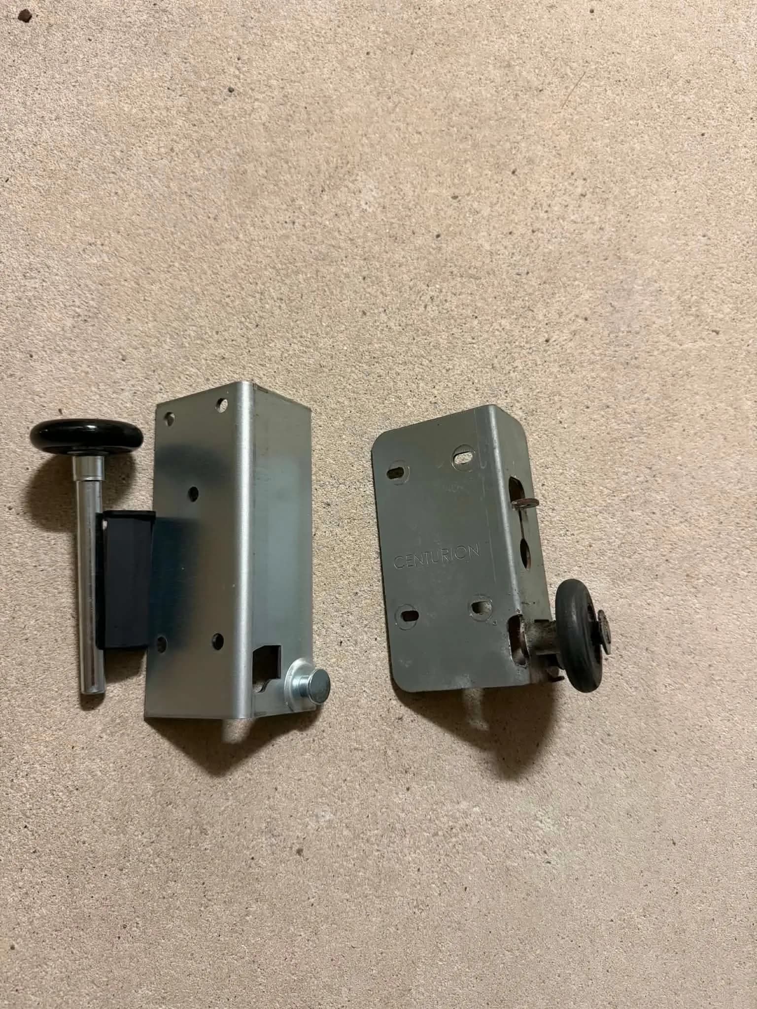 New heavy-duty garage door bottom bracket beside the worn original Centurion bracket in Forrestfield, Perth New heavy-duty garage door bottom bracket beside the worn original Centurion bracket in Forrestfield, Perth
