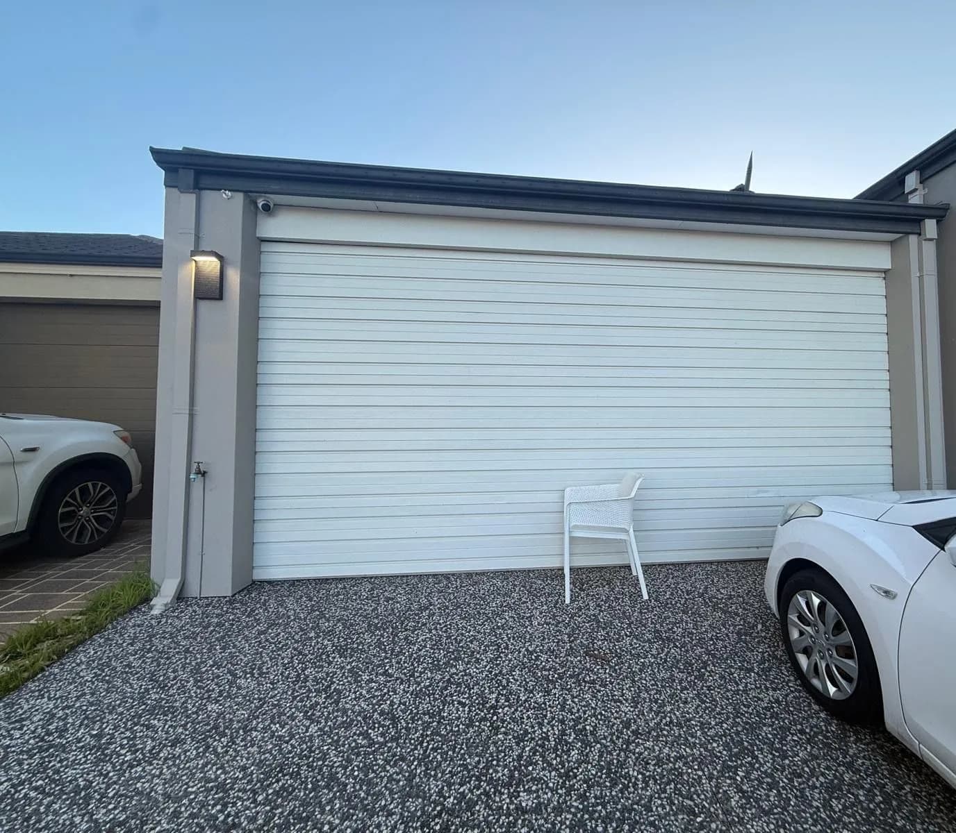 The same white roller garage door in Byford, Perth closed level after the cable was re-seated and re-tensioned The same white roller garage door in Byford, Perth closed level after the cable was re-seated and re-tensioned