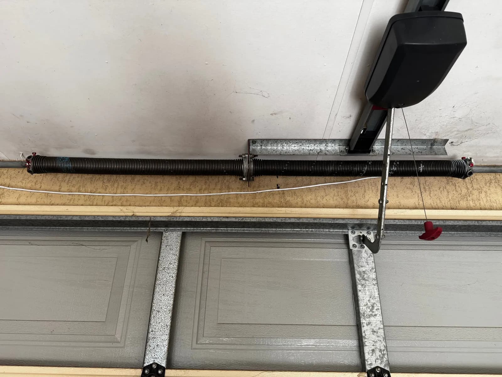 New pair of black torsion springs installed above a grey sectional garage door in Caversham, Perth New pair of black torsion springs installed above a grey sectional garage door in Caversham, Perth