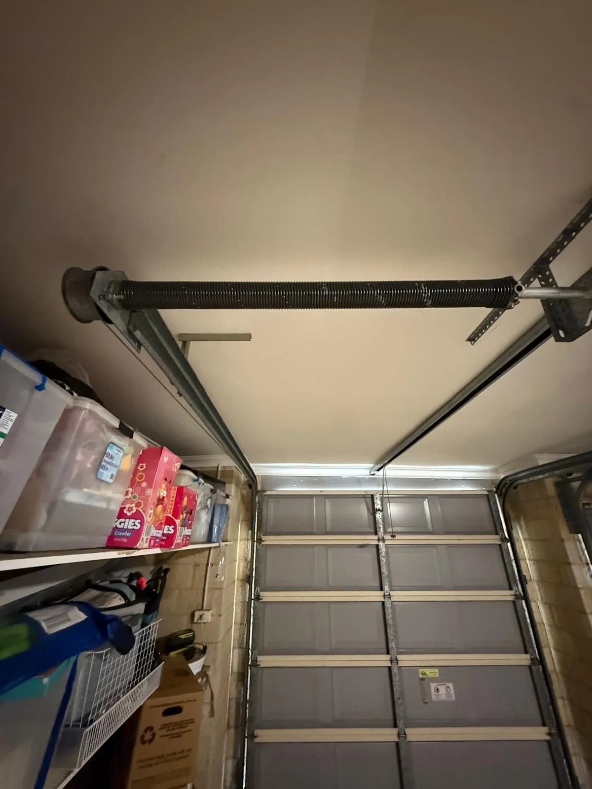 New torsion spring installed on the shaft above a grey sectional garage door in Mount Pleasant, Perth New torsion spring installed on the shaft above a grey sectional garage door in Mount Pleasant, Perth