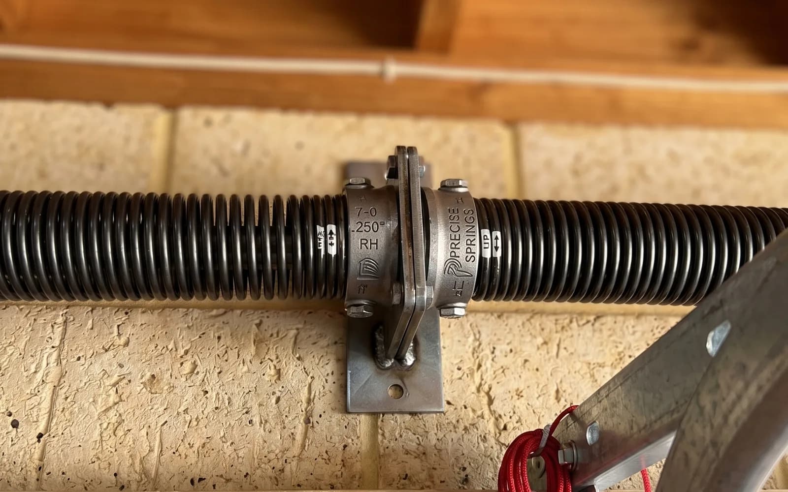 New torsion spring installed above a sectional garage door during a spring replacement in Perth New torsion spring installed above a sectional garage door during a spring replacement in Perth